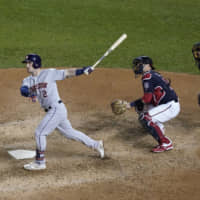 The Astros' Alex Bregman connects on a grand slam during the seventh inning in Game 4 of the World Series on Saturday in Washington. The Astros won to even the series at 2-2.