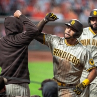 The Padres' Tommy Pham (right) is congratulated after hitting a two-run home run against the Giants in San Francisco on Sept. 26, 2020. | USA TODAY / VIA REUTERS