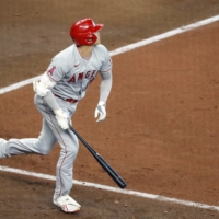 Angels designated hitter Shohei Ohtani reacts after his solo home run against the Astros on Saturday in Houston. | KYODO