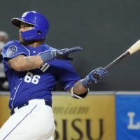 The Dragons' Dayan Viciedo drives in a run with a double against the Fighters at Sapporo Dome on Friday. | KYODO