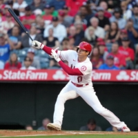 Los Angeles Angels designated hitter Shohei Ohtani hits a single in the first inning against the Boston Red Sox at Angel Stadium in Anaheim, California, on Monday. | USA TODAY / VIA REUTERS