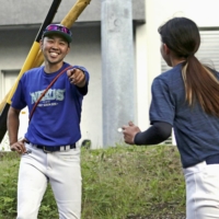 Minoru Ikari (left), manager of the Tokai Nexus women's baseball team, came out publicly as a trans man last year. | KYODO