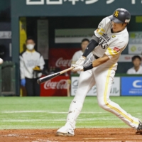 SoftBank's Yuki Yanagita hits a third-inning grand slam against Seibu in Fukuoka on Sunday. | KYODO