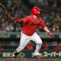 Carp pinch hitter Ryuhei Matsuyama hits a three-run double against the Tigers during the eighth inning at Koshien Stadium in Nishinomiya, Hyogo Prefecture. | KYODO